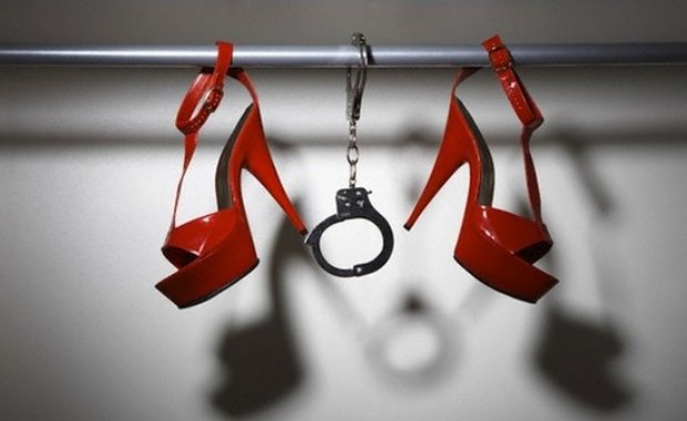 Still Life of Red Shoes and Handcuffs in Closet